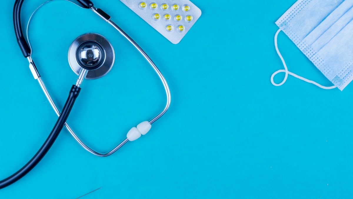 The concept of healing. Flat lay composition. Stethoscope, shopping trolley with capsule on a blue background. More of my photos and videos Adobe Stock:http://bit.ly/3RqlciK More of my photos and videos Shutterstock: https://www.shutterstock.com/g/ALEKSANDRBERDYUGIN My email: bermix999@gmail.com